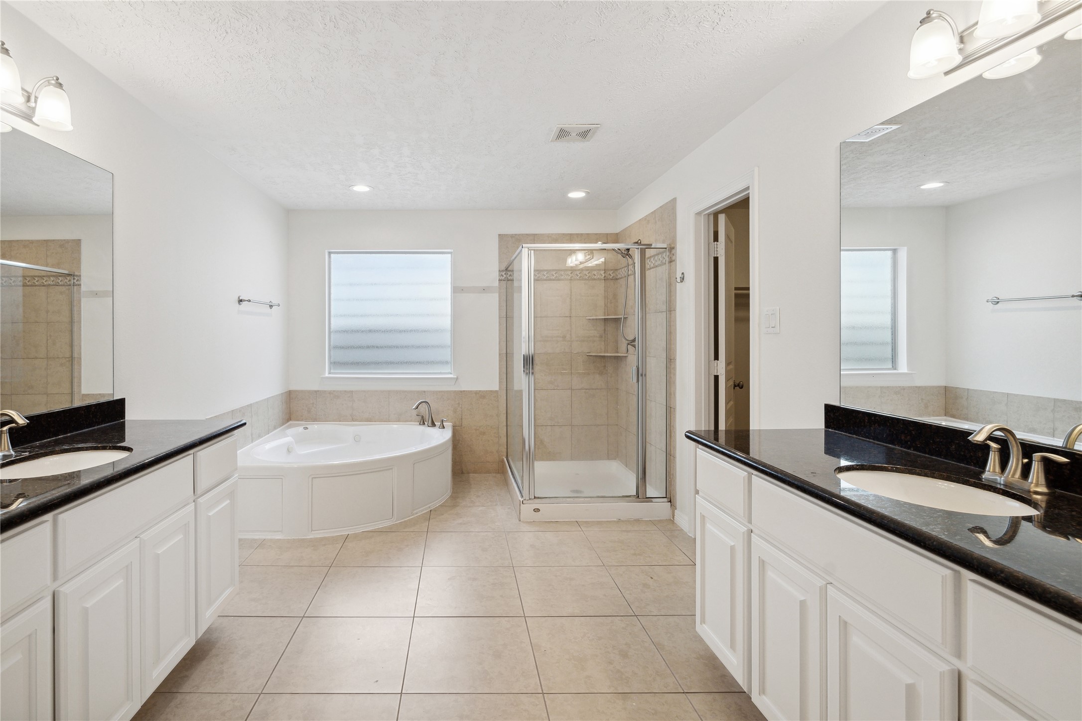 1613 West 15th Street Houston, TX 77008 - Photo 17 of 25 a spacious bathroom with a granite countertop sink a toilet a mirror a bathtub and shower