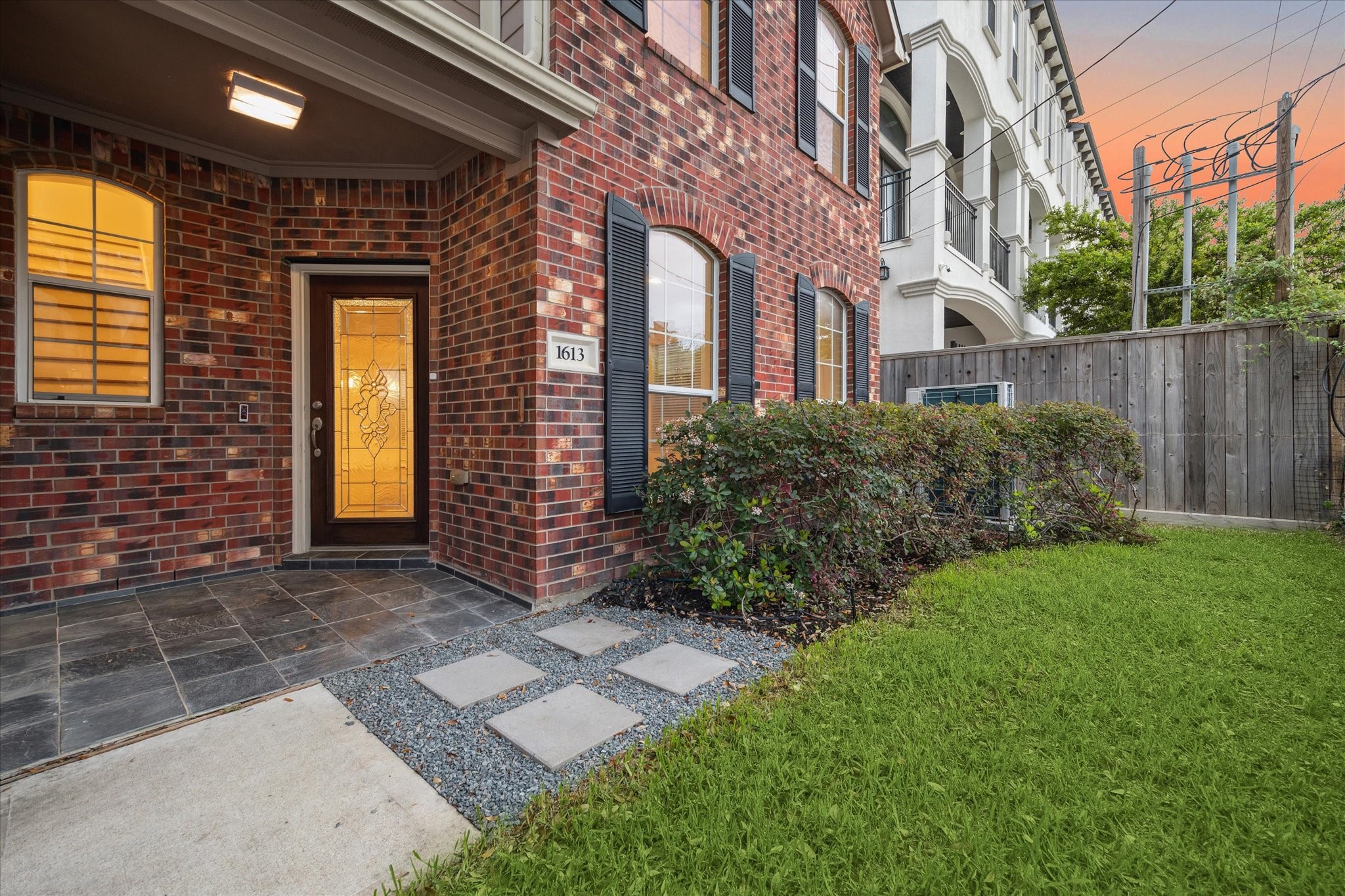 1613 West 15th Street Houston, TX 77008 - Photo 4 of 25 a view of a brick building next to a yard