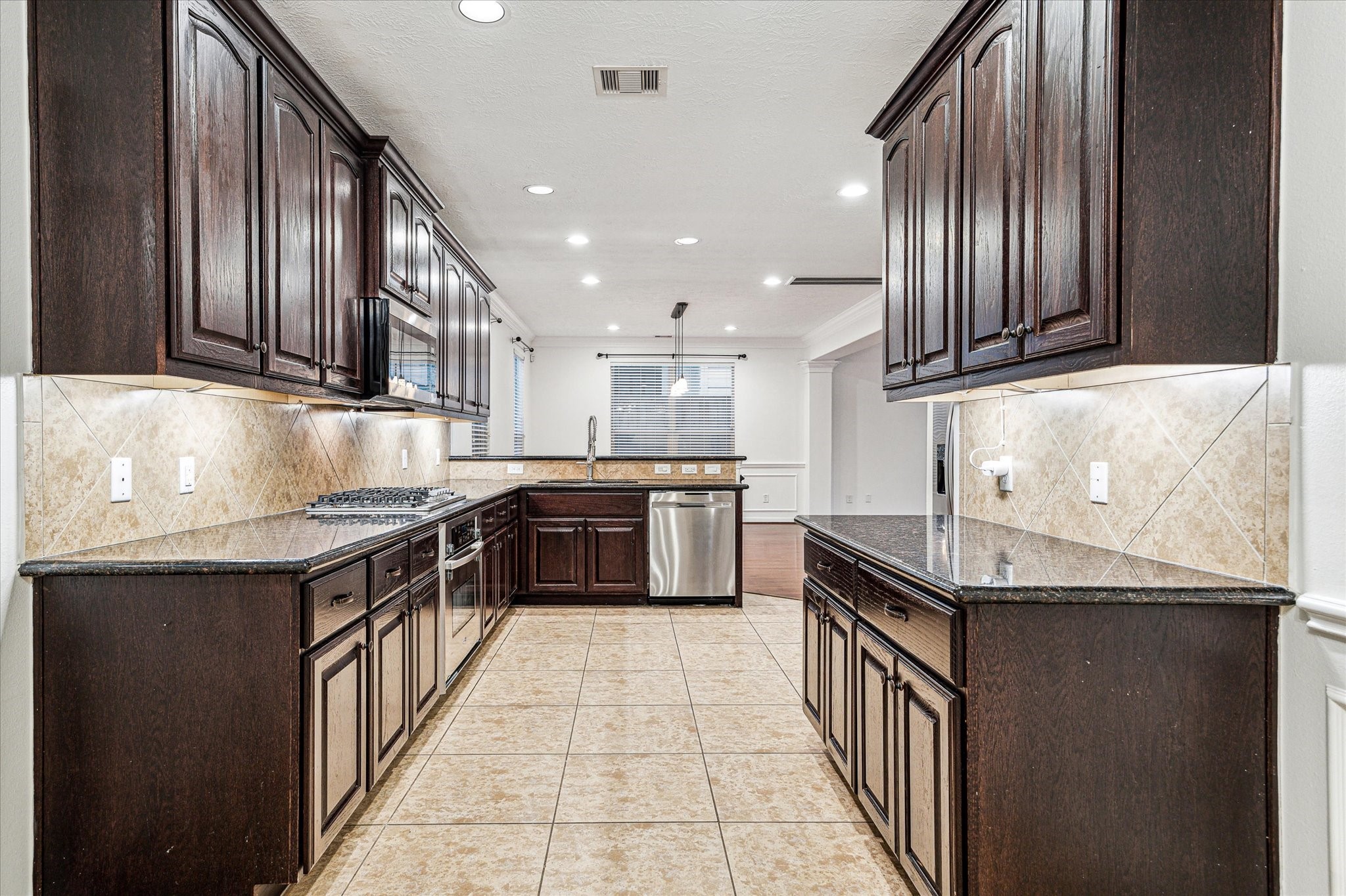 1613 West 15th Street Houston, TX 77008 - Photo 7 of 25 a kitchen with stainless steel appliances granite countertop a sink and stove