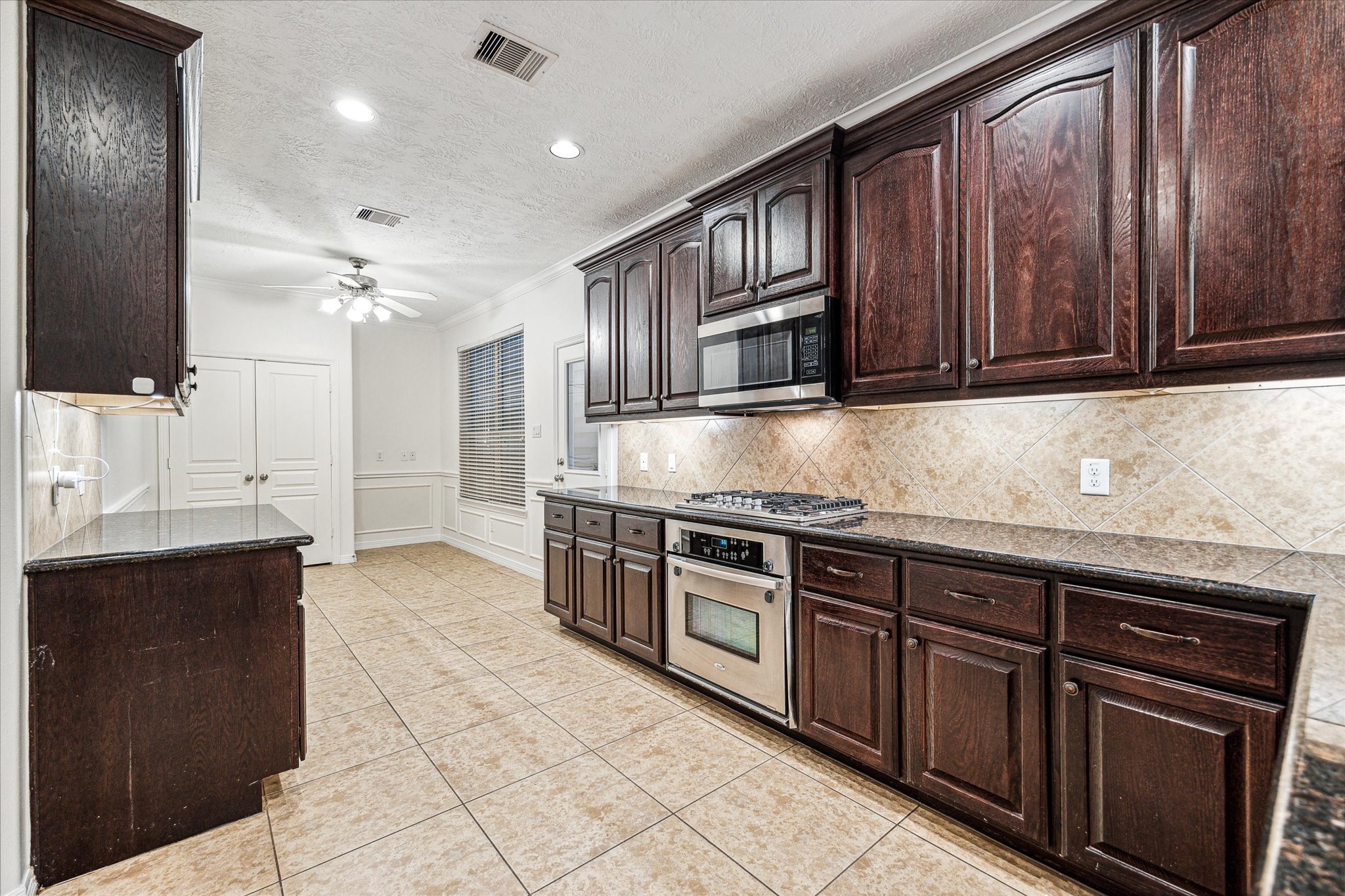 1613 West 15th Street Houston, TX 77008 - Photo 8 of 25 a kitchen with stainless steel appliances granite countertop a stove a sink and a microwave