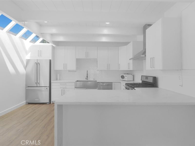 400 Monterey Road, Unit 11 Glendale, CA 91206 - Photo 5 of 14 a large white kitchen with stainless steel appliances