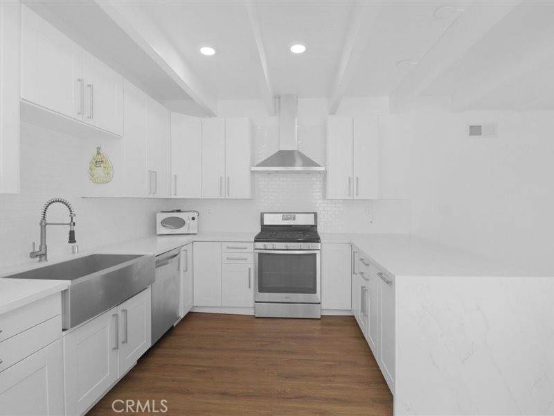 400 Monterey Road, Unit 11 Glendale, CA 91206 - Photo 7 of 14 a kitchen with stainless steel appliances granite countertop a sink and a stove top oven