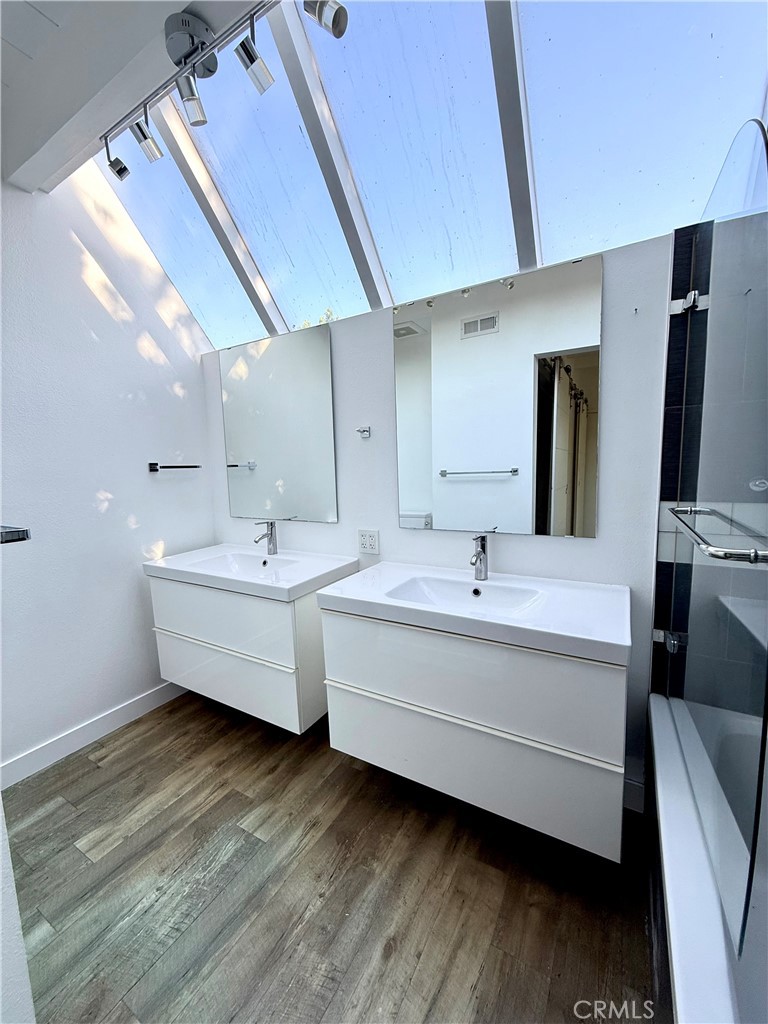 400 Monterey Road, Unit 11 Glendale, CA 91206 - Photo 10 of 14 a bathroom with a double vanity sink and mirror