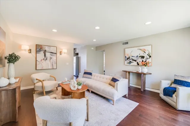 a spacious bedroom with a bed and a couch