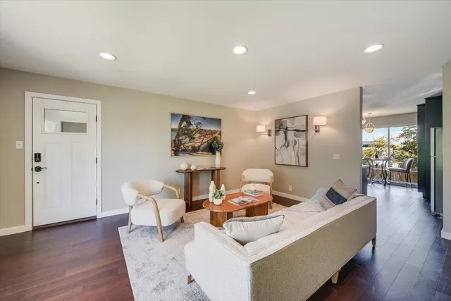 a living room with furniture and wooden floor