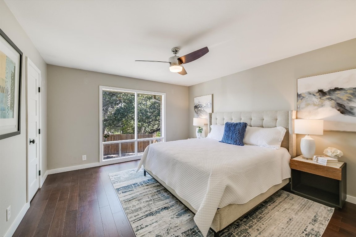5332 Balcones Drive, Unit I Austin, TX 78731 - Photo 8 of 16 a bedroom with a large bed and a window