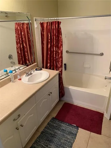 a bathroom with a tub sink and shower