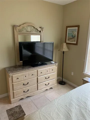 a bedroom with a bed a fireplace and a television