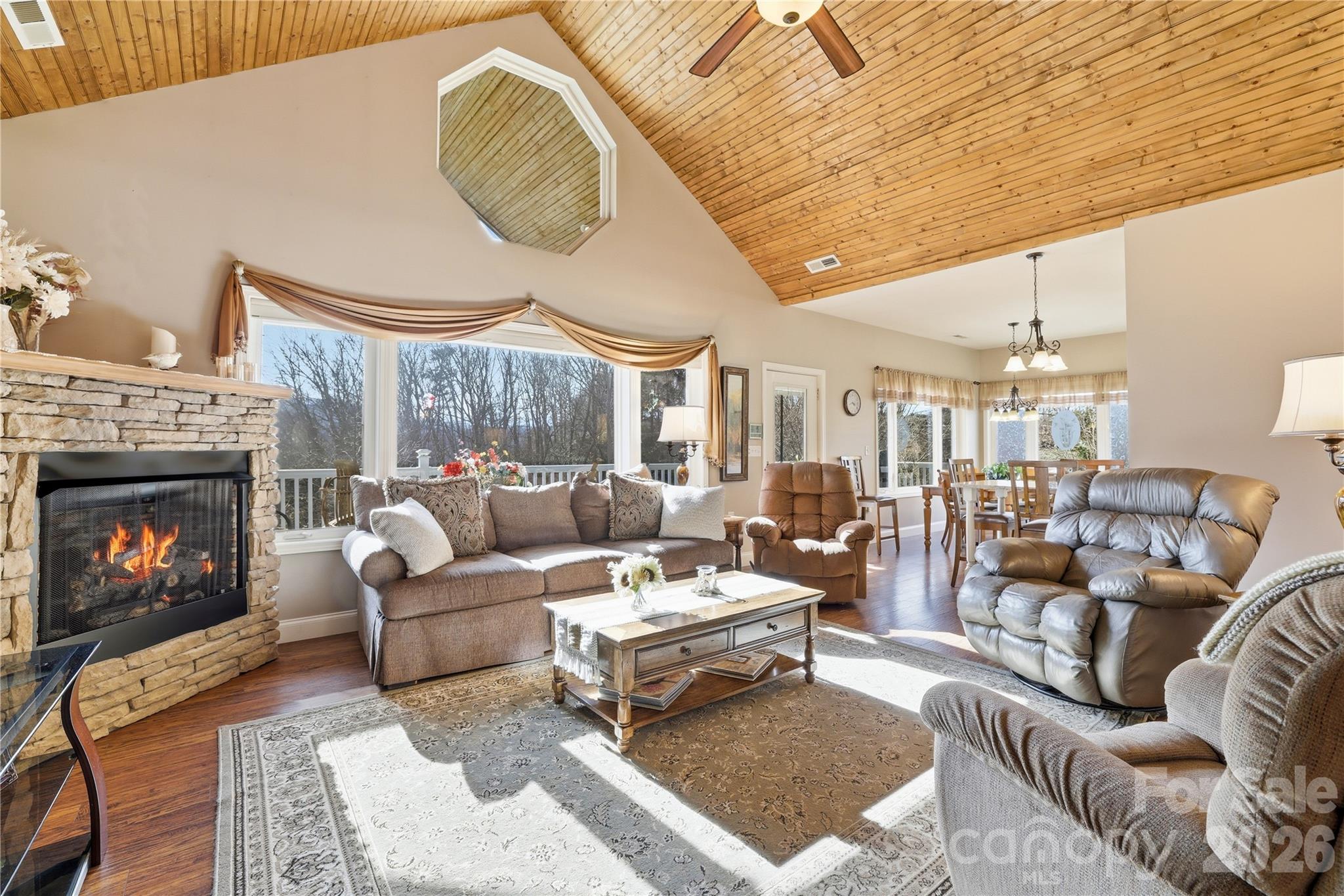 140 Debbie Loop Waynesville, NC 28786 - Photo 11 of 47 a living room with furniture a fireplace and a large window