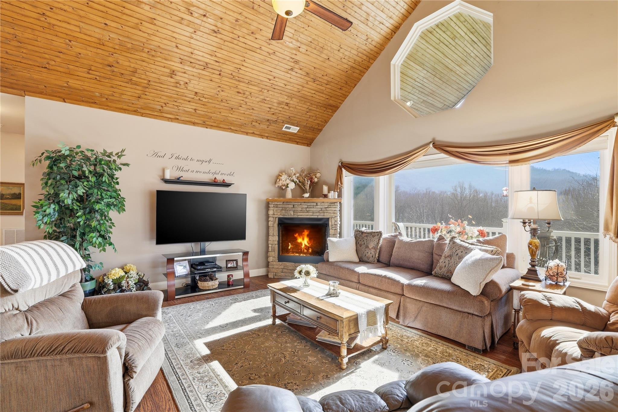 140 Debbie Loop Waynesville, NC 28786 - Photo 12 of 47 a living room with furniture a large window and a flat screen tv
