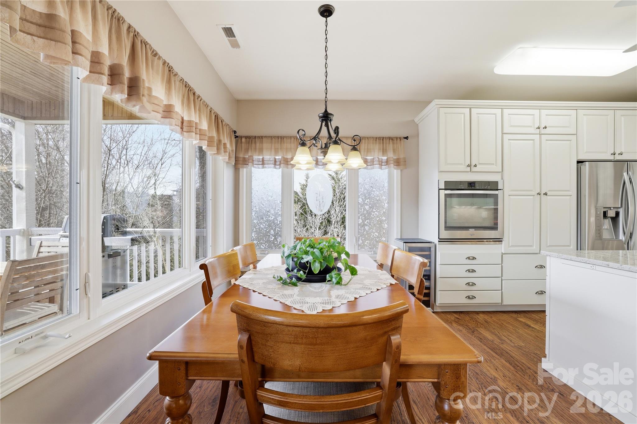 140 Debbie Loop Waynesville, NC 28786 - Photo 13 of 47 a dining room with furniture a chandelier and wooden floor