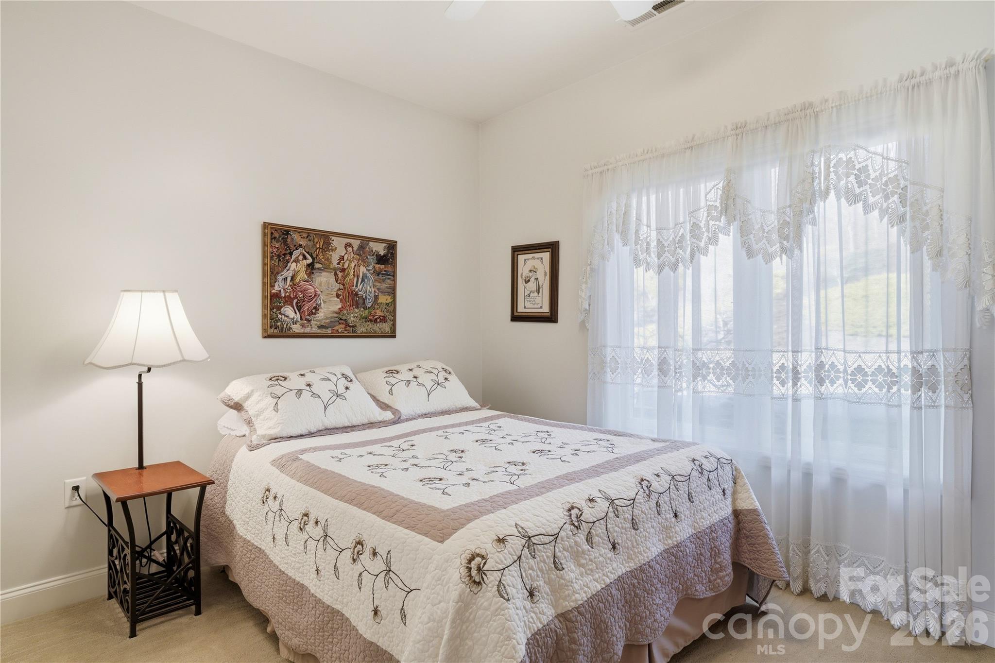 140 Debbie Loop Waynesville, NC 28786 - Photo 25 of 47 a bedroom with a bed and a lamp