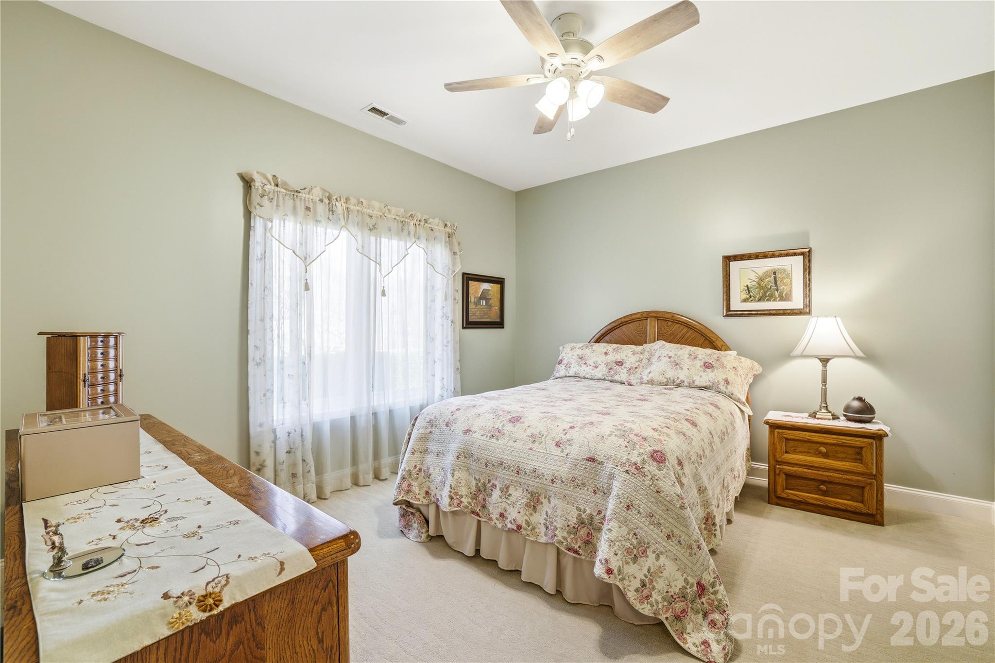 140 Debbie Loop Waynesville, NC 28786 - Photo 28 of 47 a bedroom with a bed and a chandelier