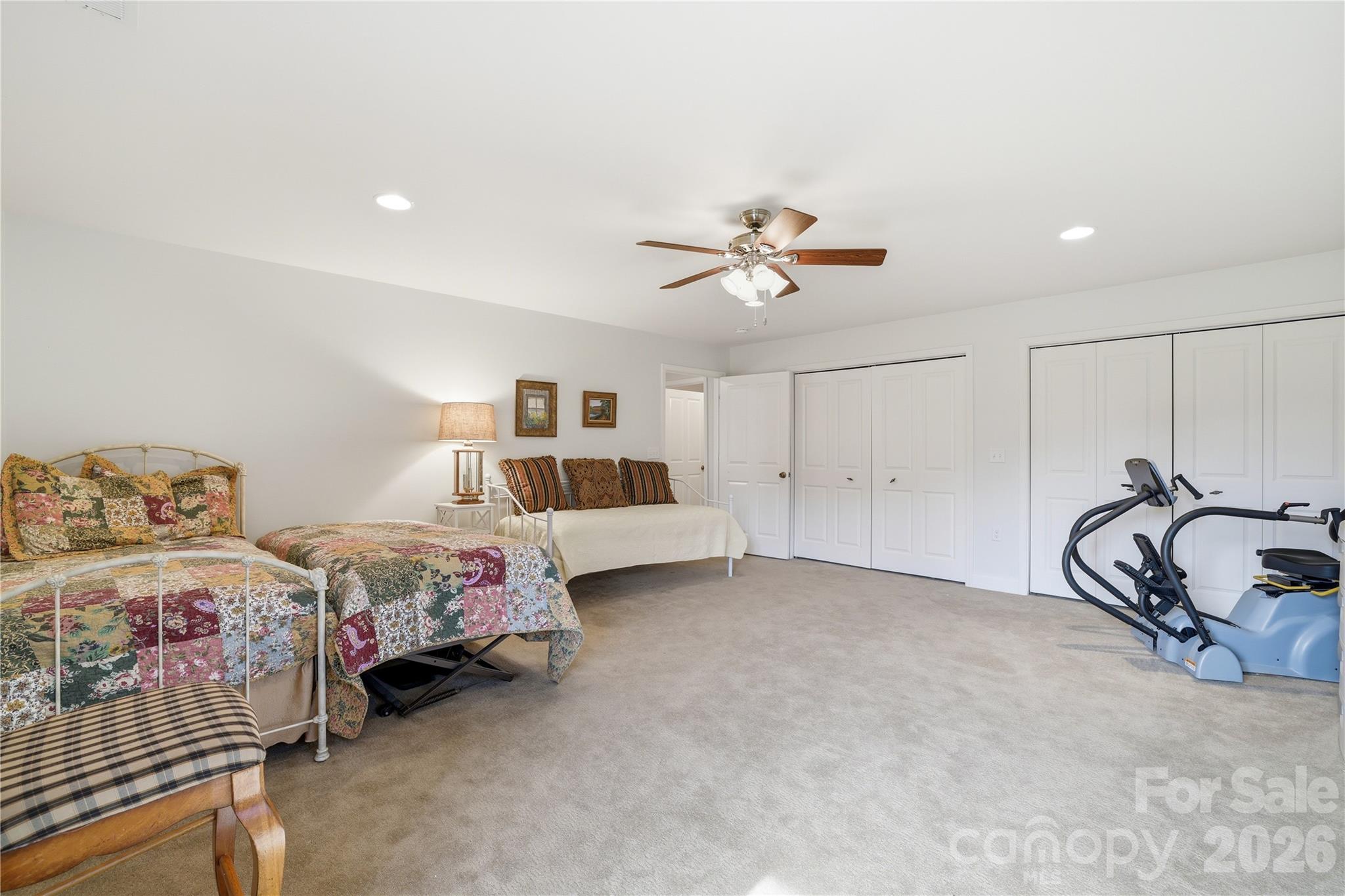 140 Debbie Loop Waynesville, NC 28786 - Photo 36 of 47 a spacious bedroom with two bed and a chandelier