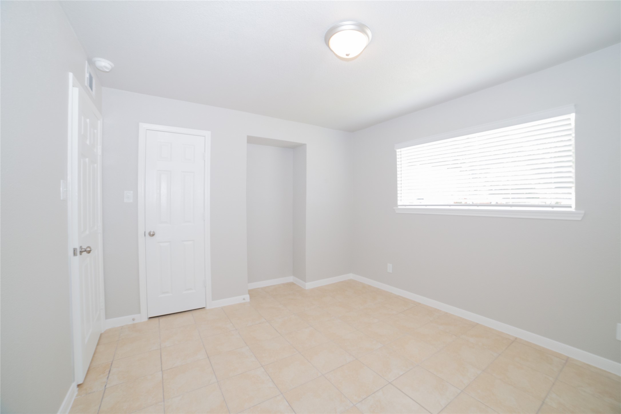 2010 North Travis Street, Unit 116 Liberty, TX 77575 - Photo 7 of 11 a bedroom with a bed and a window