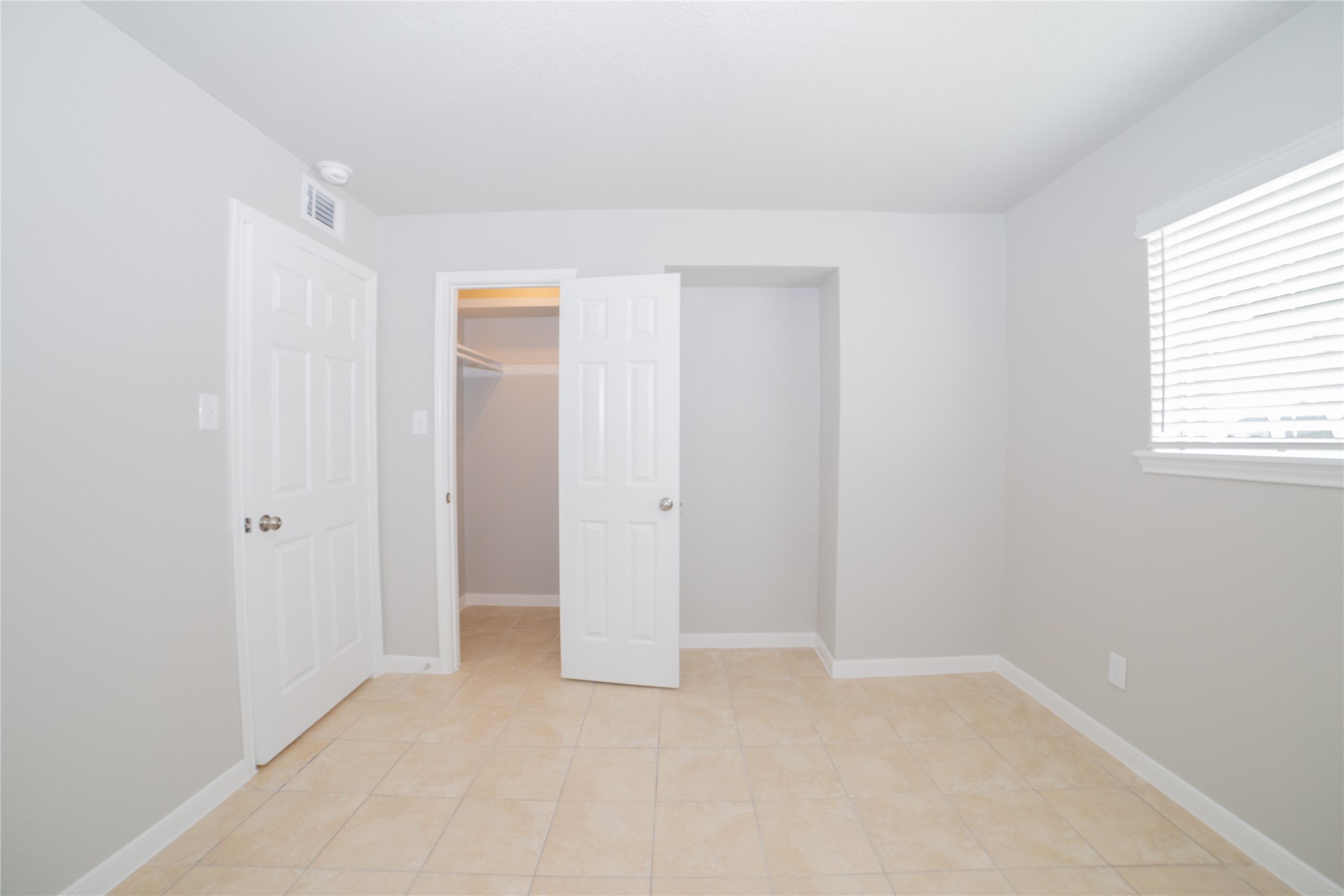 2010 North Travis Street, Unit 116 Liberty, TX 77575 - Photo 8 of 11 an empty room with windows and closet