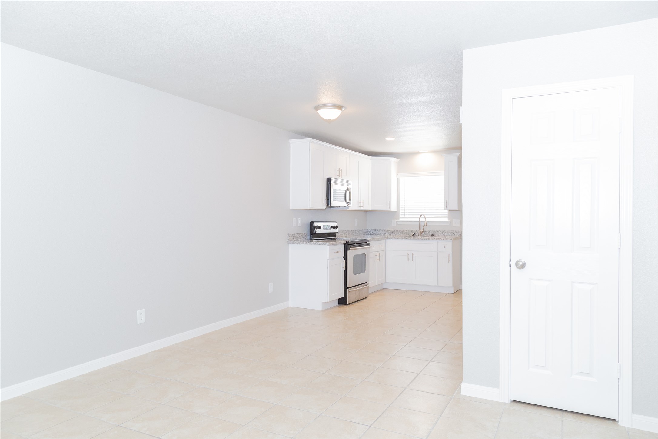 2010 North Travis Street, Unit 116 Liberty, TX 77575 - Photo 10 of 11 a view of a kitchen with white cabinets and a sink