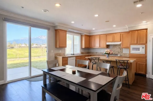 a kitchen with a table chairs sink and cabinets