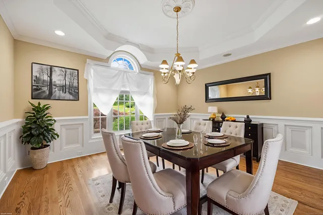 a view of a dining room with furniture wooden floor and a chandelier