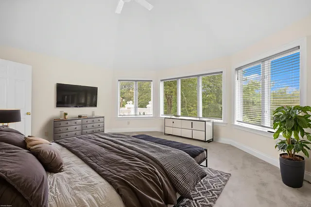 a bedroom with furniture and a flat screen tv