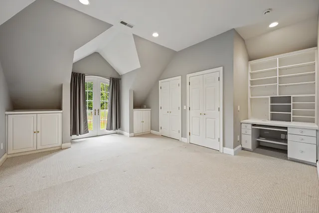 an empty room with closet and a window