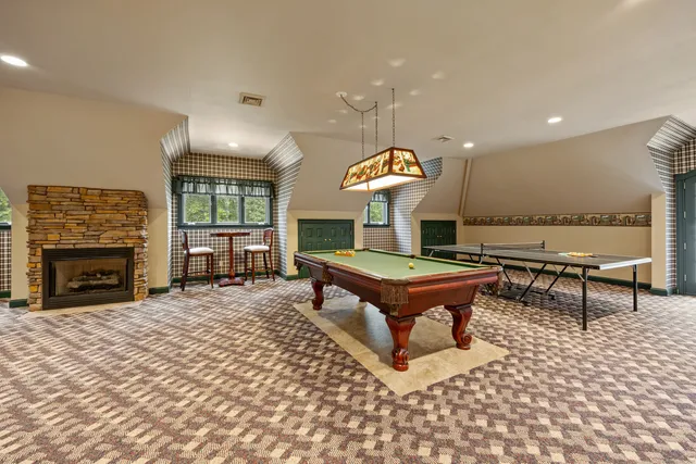 a living room with fireplace furniture and a fireplace