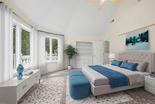 a bedroom with a large bed and a window