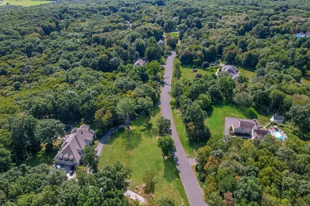 an aerial view of residential house with outdoor space and swimming pool