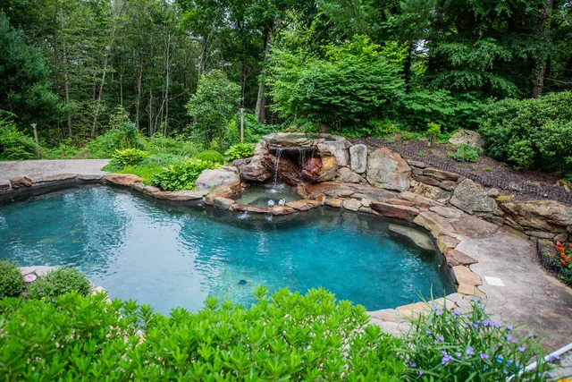 an aerial view of a house with a yard and lake view