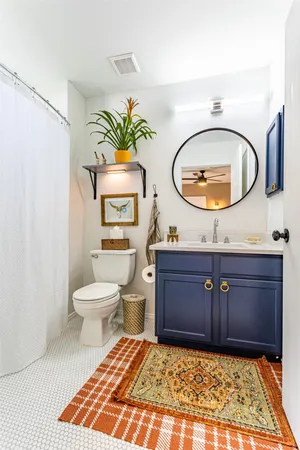 a bathroom with a sink mirror and toilet