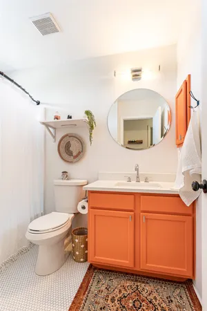 a bathroom with a toilet a sink and a mirror