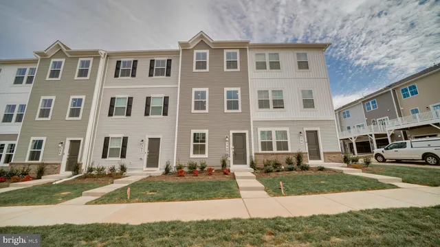 a front view of a residential apartment building with a yard