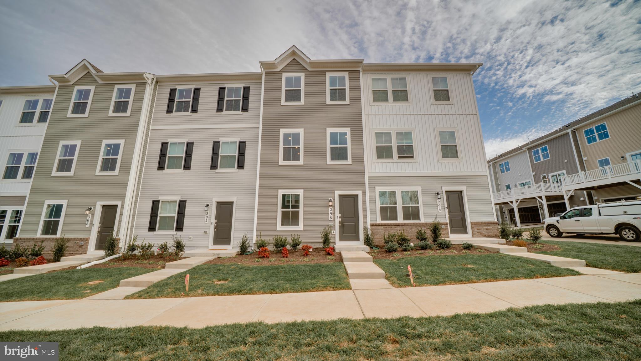 a front view of a residential apartment building with a yard