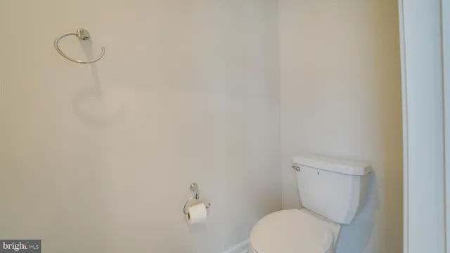 a white toilet sitting next to a white sink