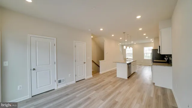 a view of a kitchen with a sink and a refrigerator