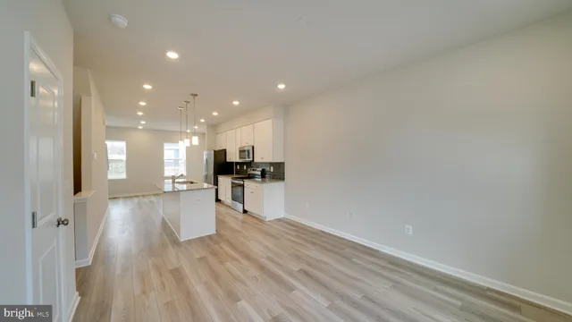 a kitchen with stainless steel appliances kitchen island a refrigerator sink and stove