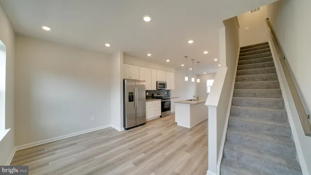 a view of a room with wooden floor and window
