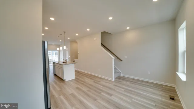 a kitchen with sink a microwave and cabinets