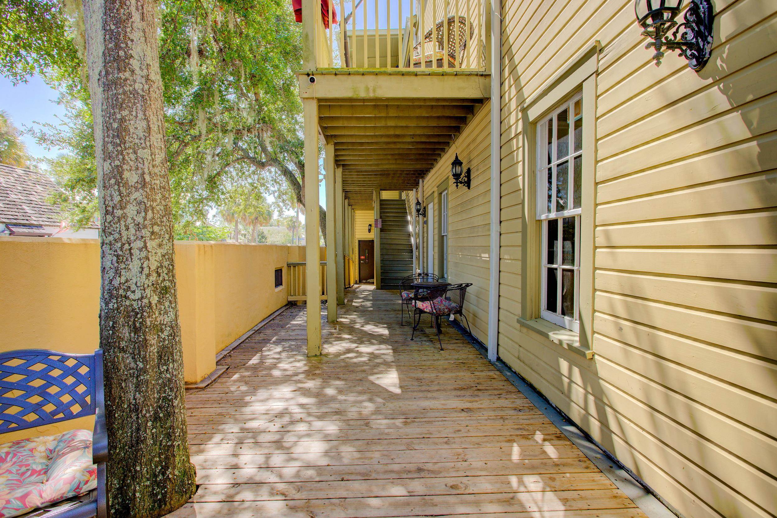 29 Cuna Street St. Augustine, FL 32084 - Photo 12 of 69 a view of a balcony with chairs and wooden fence