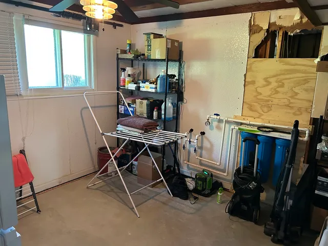 a work room with furniture and a window