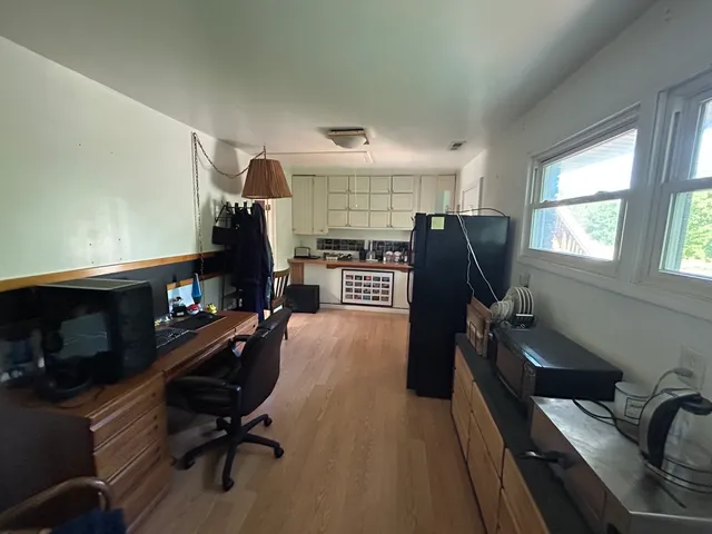 a view of a workspace with furniture and a window