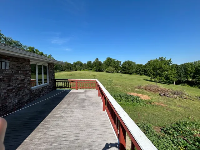 a view of a yard with a wooden fence