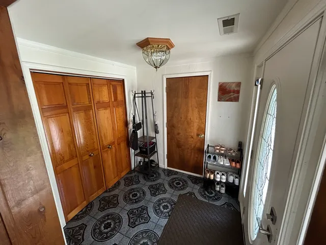 walk in closet with window and refrigerator