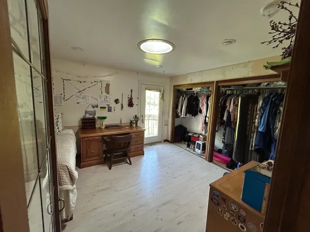 a living room with furniture and a mirror