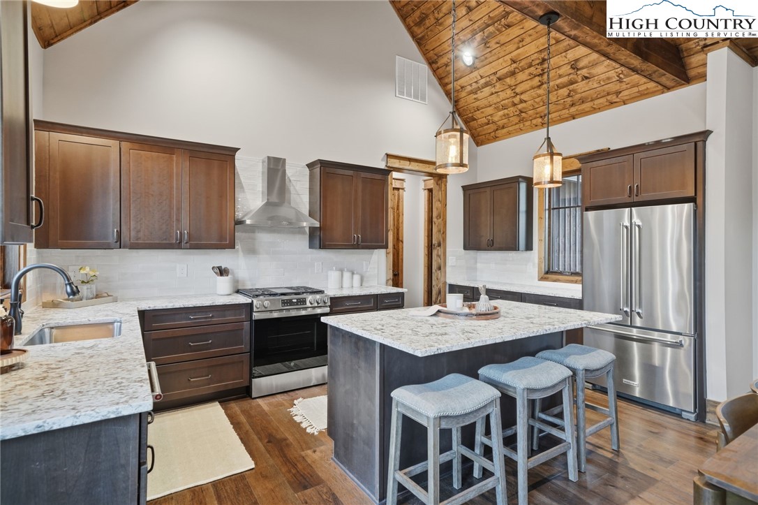 123 High Country Overlook Overlook, Unit OVERLOOK Banner Elk, NC 28604 - Photo 20 of 48 a kitchen with stainless steel appliances granite countertop a sink stove and refrigerator