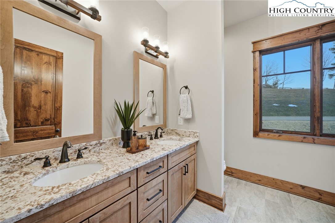 123 High Country Overlook Overlook, Unit OVERLOOK Banner Elk, NC 28604 - Photo 29 of 48 a bathroom with a granite countertop sink and a mirror