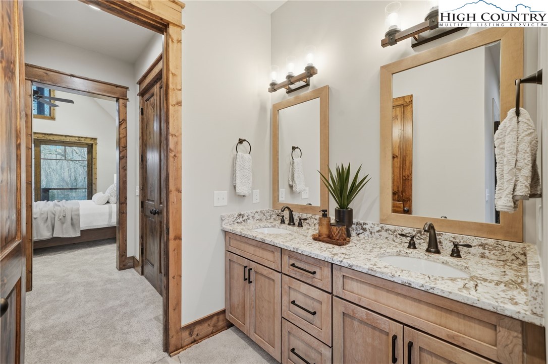 123 High Country Overlook Overlook, Unit OVERLOOK Banner Elk, NC 28604 - Photo 31 of 48 a en suite bathroom with a granite countertop sink and a mirror