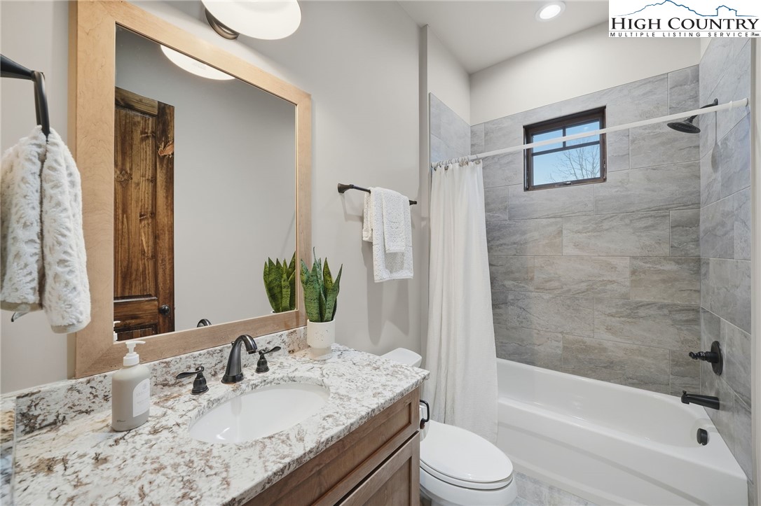 123 High Country Overlook Overlook, Unit OVERLOOK Banner Elk, NC 28604 - Photo 34 of 48 a bathroom with a granite countertop tub sink toilet and mirror