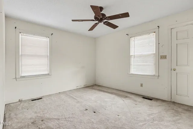 a view of room with a ceiling fan