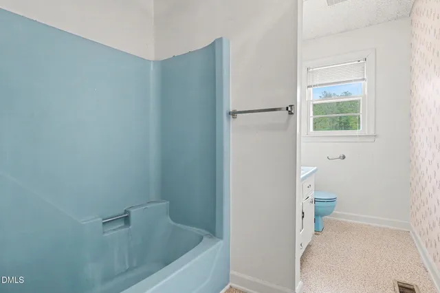 a bathroom with a bathtub and toilet